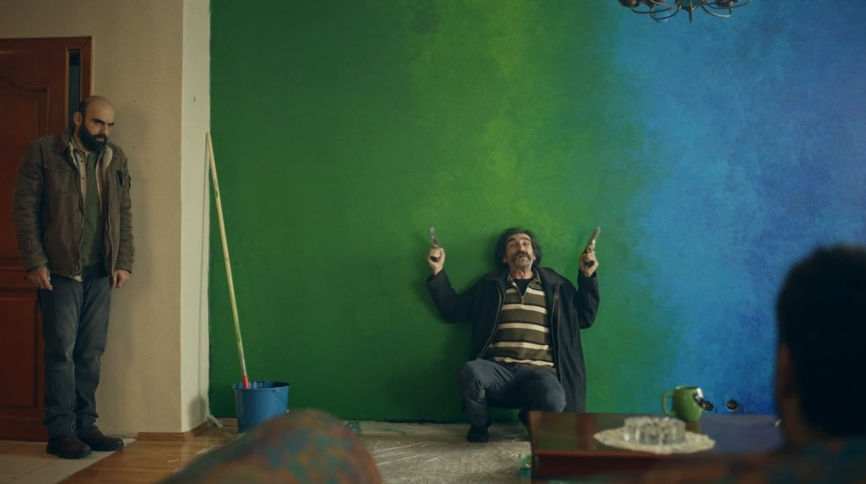 a miserable man painting the wall