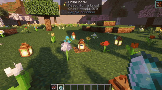 Fairies circling a shrine while a lantern-lit garden of farm plots grows out from it
