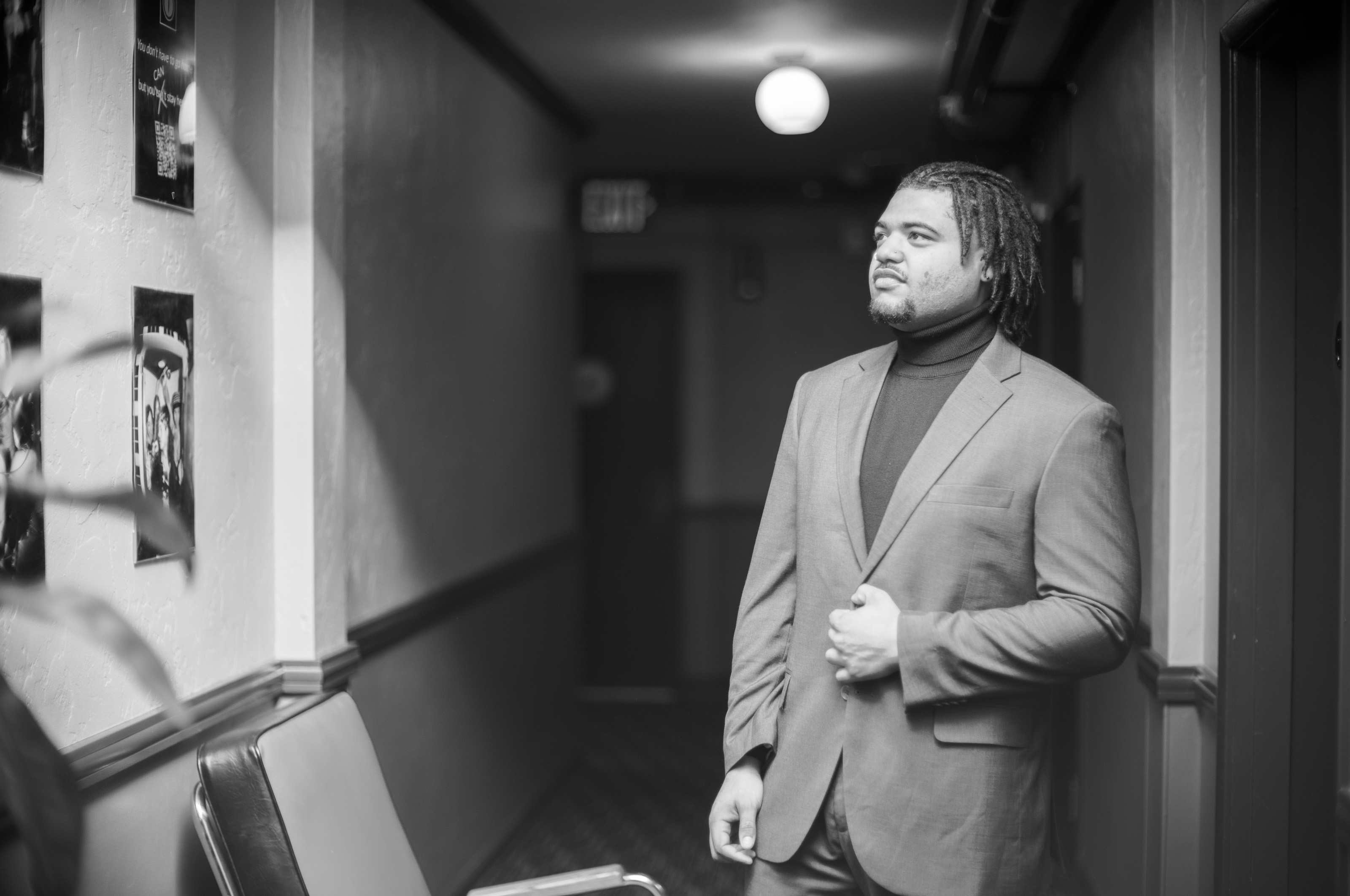 M standing in hallway