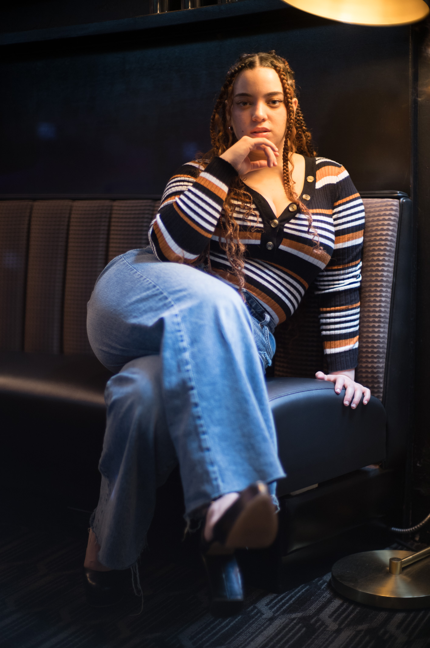 Model sitting under lamp