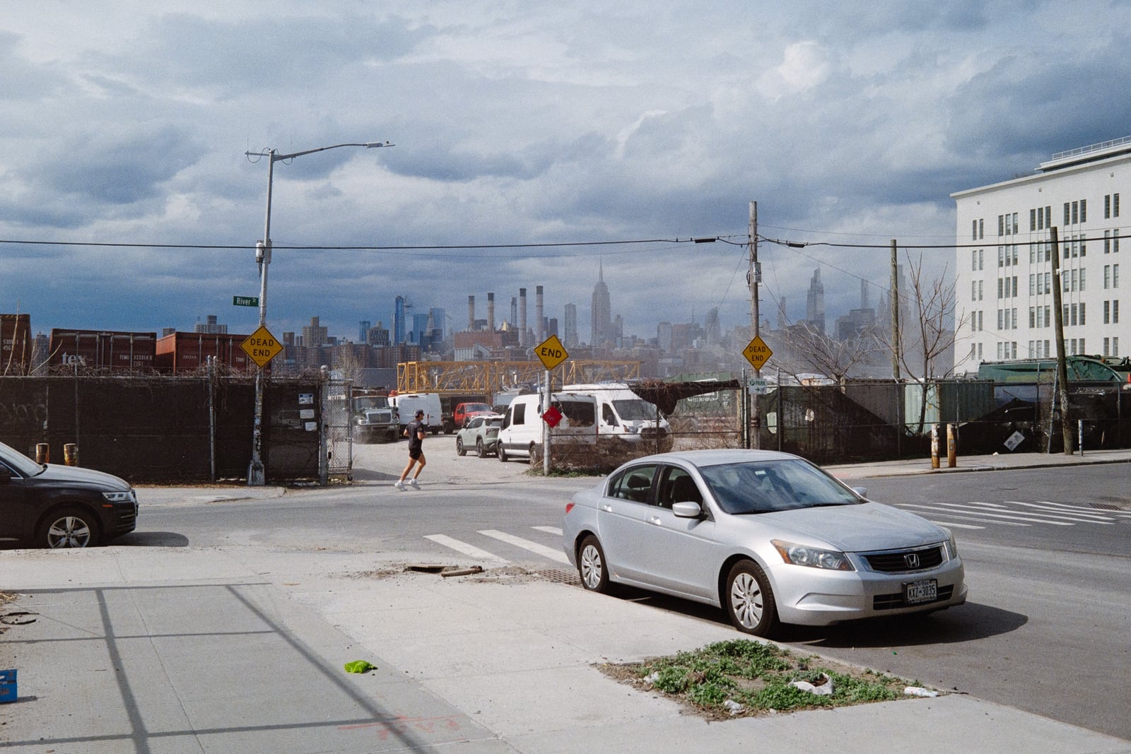 New York skyline with cars and a running figure