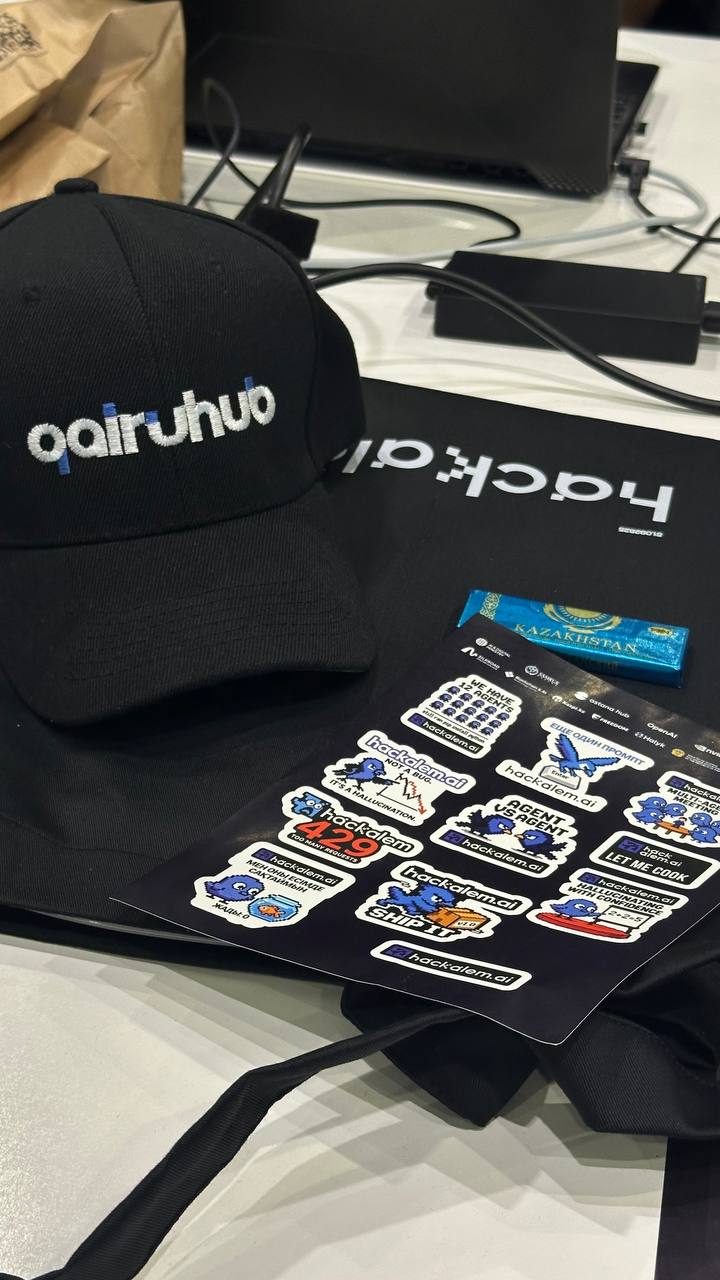 A qairuhub cap and HackAlem stickers