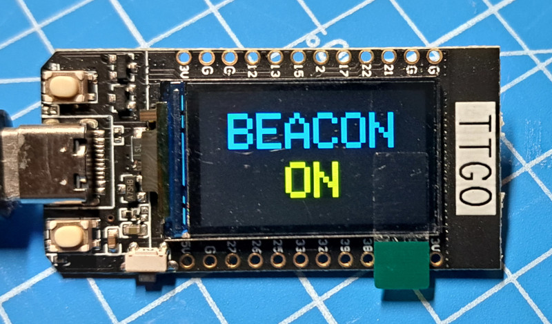 Image of a TTGO showing "BEACON ON" on the display.