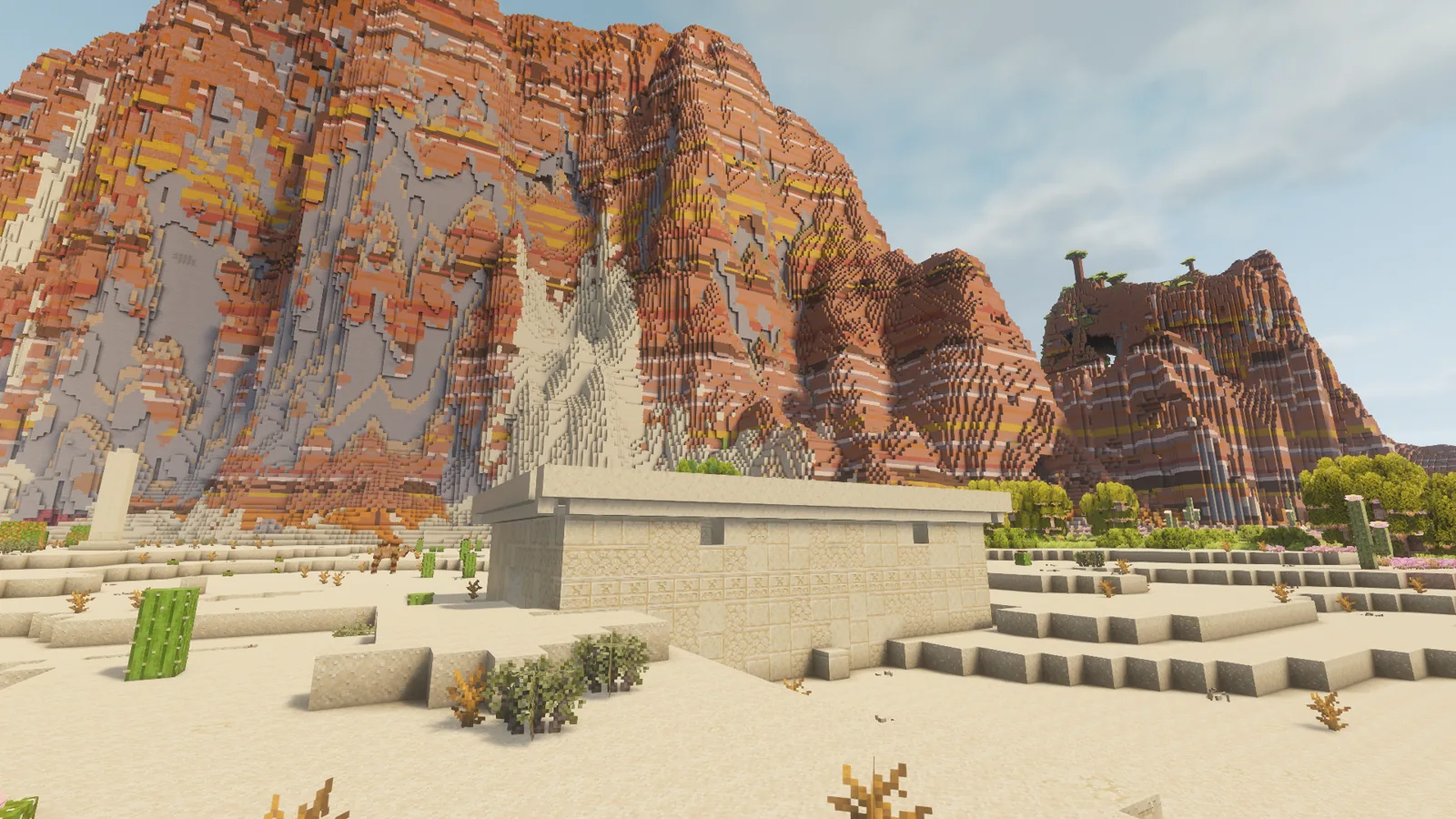 A sandstone temple below red cliffs