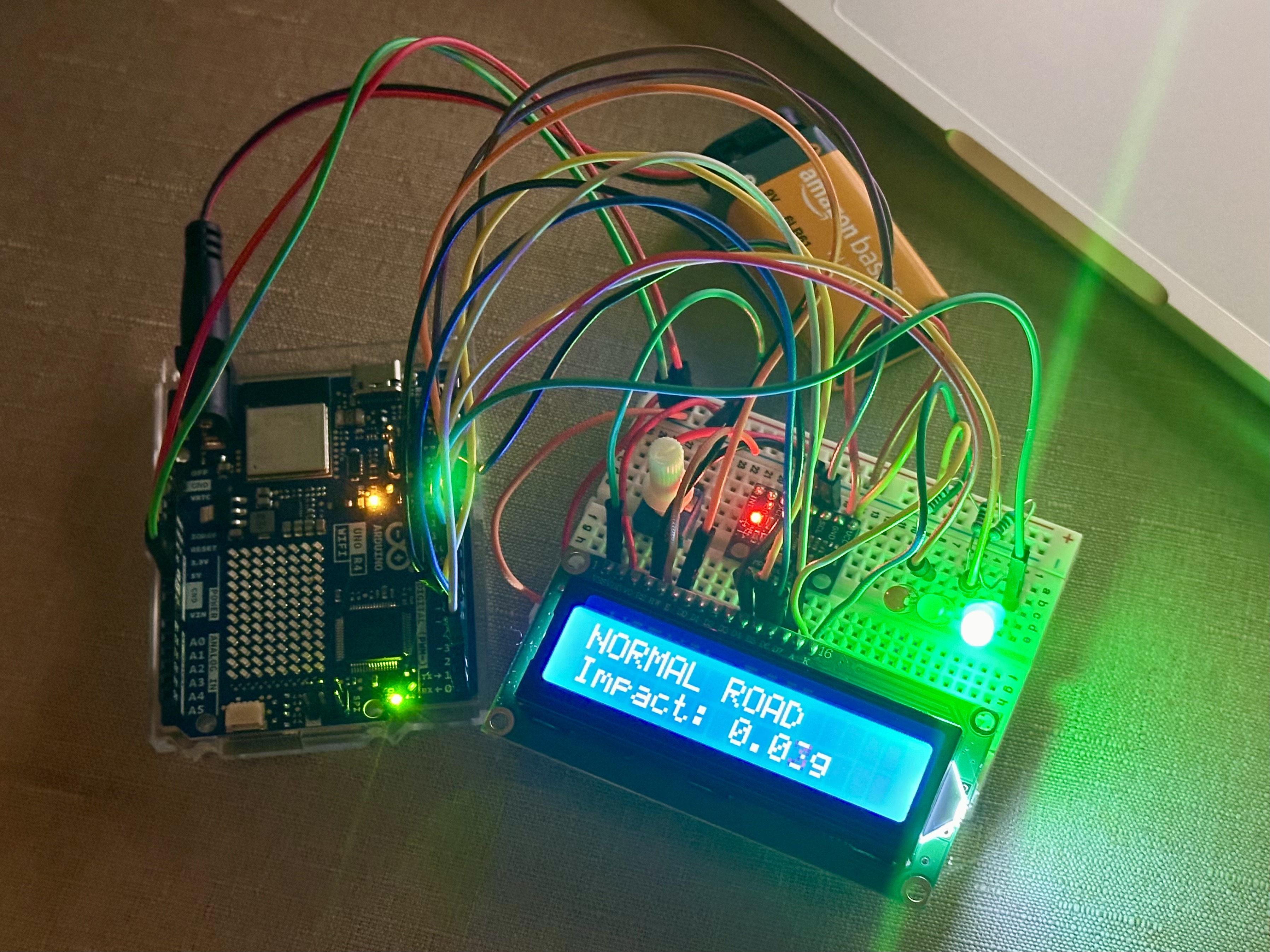 Assembled RoadRelay prototype with Arduino, breadboard, sensor, LCD, and illuminated green indicator