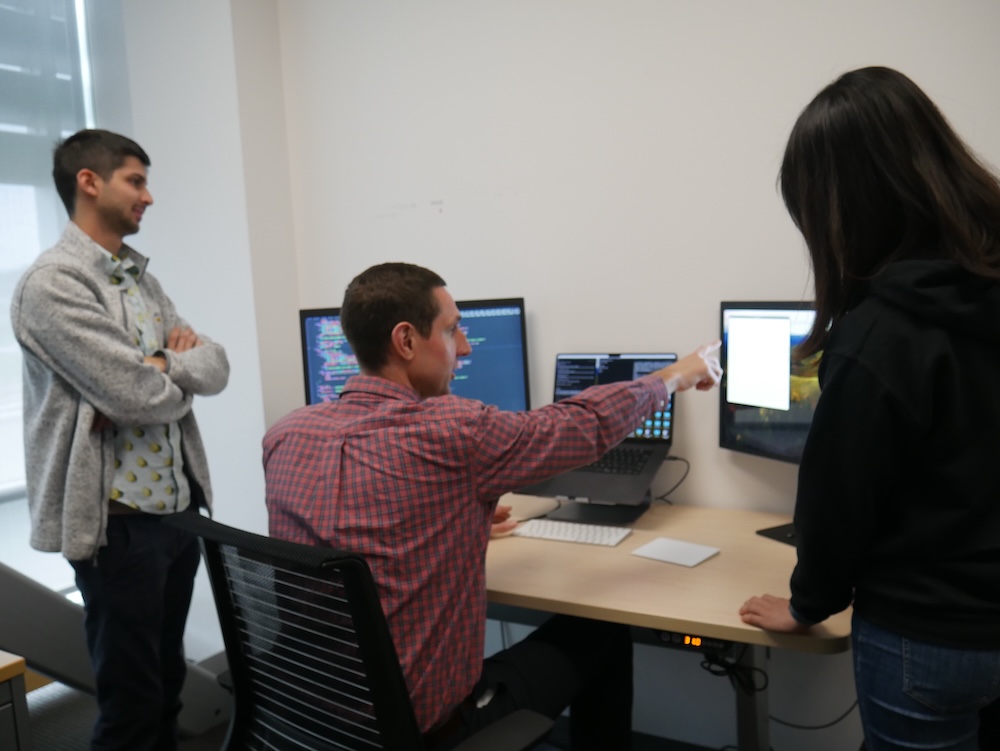 Erik pointing at a computer