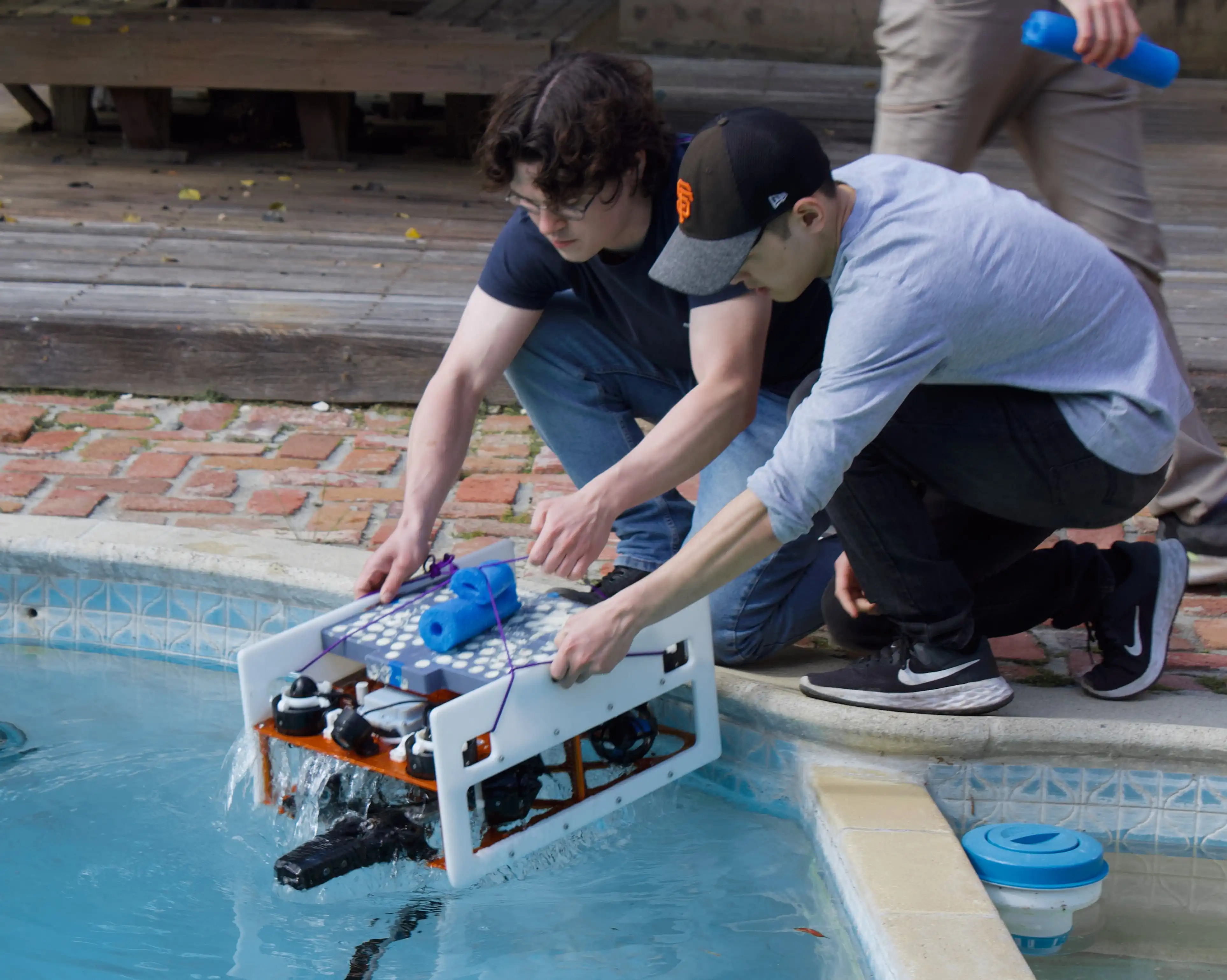 Liam Gilligan and Isaac Eda deploy SeaHawk II for a pool test