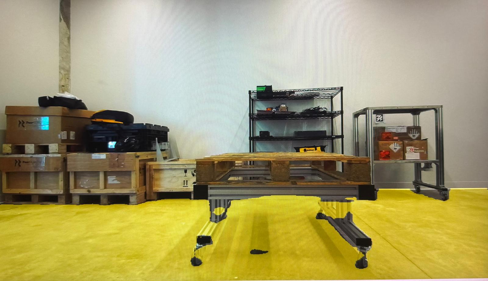 Warehouse floor with a yellow segmentation overlay; stacked pallets on the left, a pallet on a wheeled cart in the centre, a shelf behind