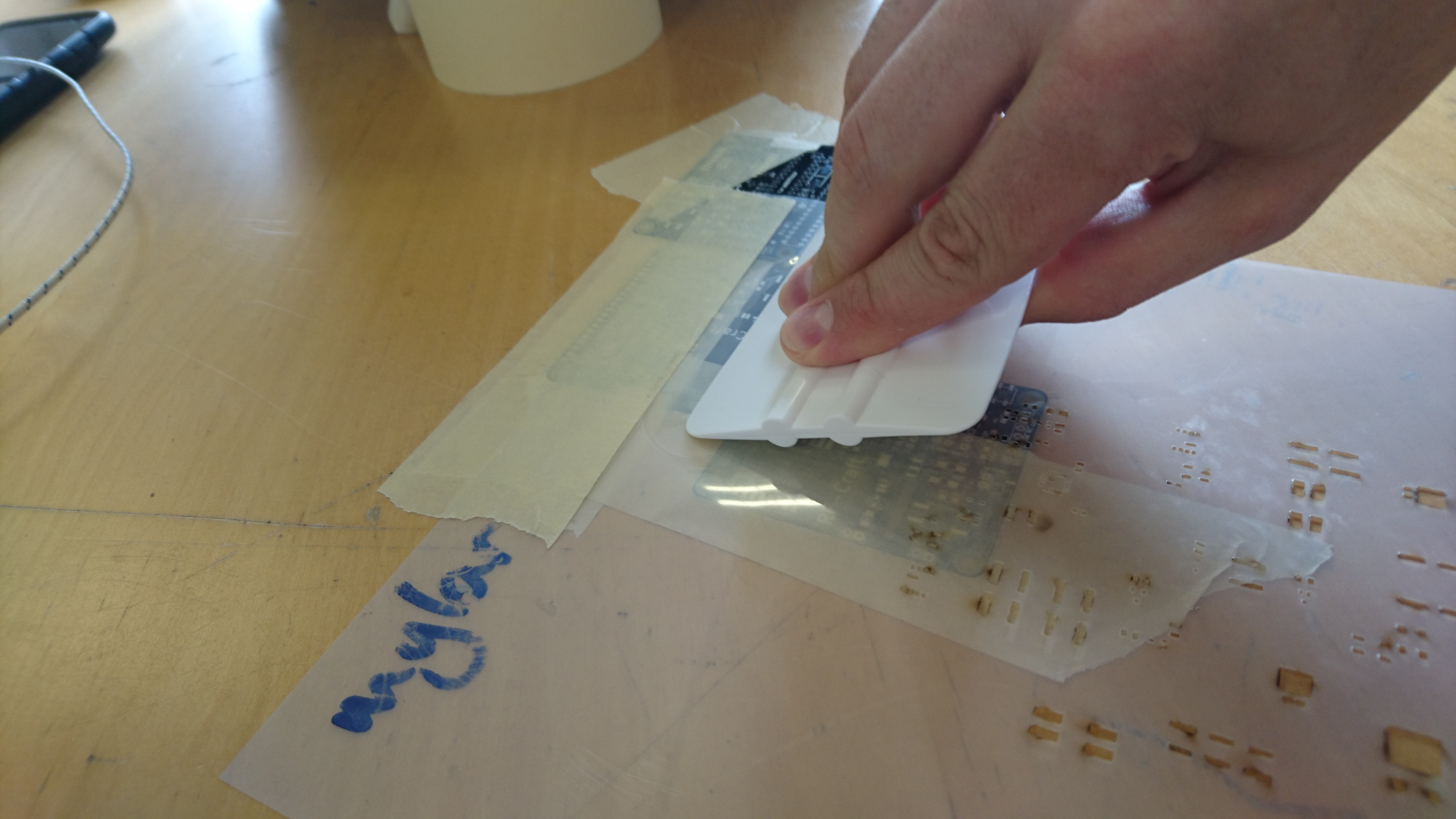 Squeegee at approx a 30 degree angle to the board ready to wipe paste into the stencil