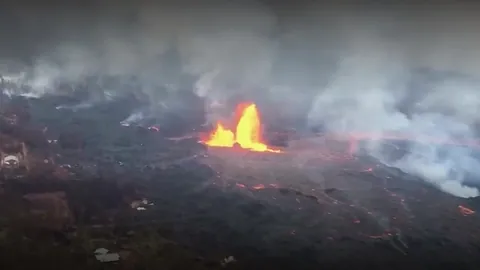 Aerial footage of the Kilauea Fissure 8 lava fountain with a caption card.