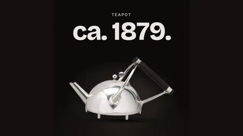 A silver teapot on black with rising steam.