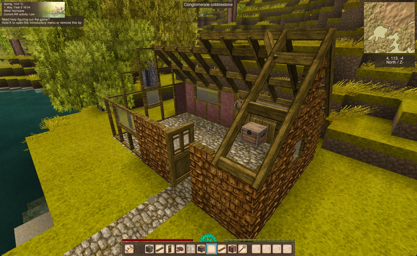 A finished siding house with brick, shakes, a glass wall and an open roof frame