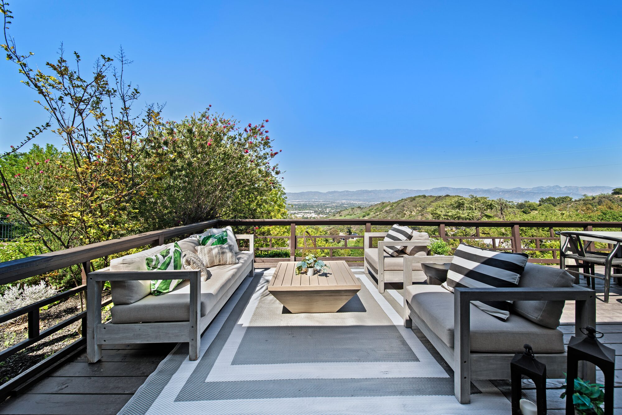 Outdoor deck staged for entertaining with valley views