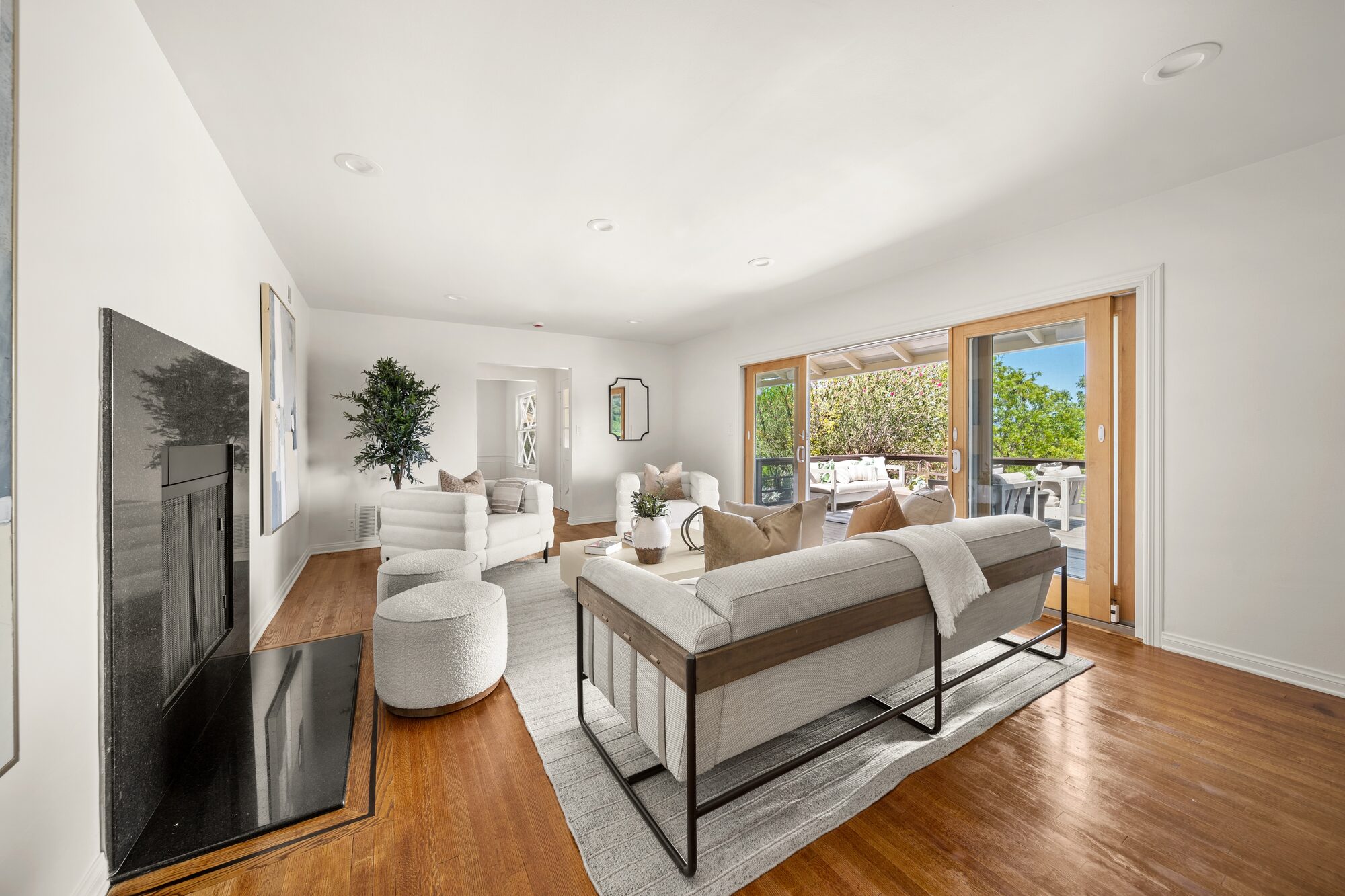 Staged living room with fireplace and refreshed wood floors