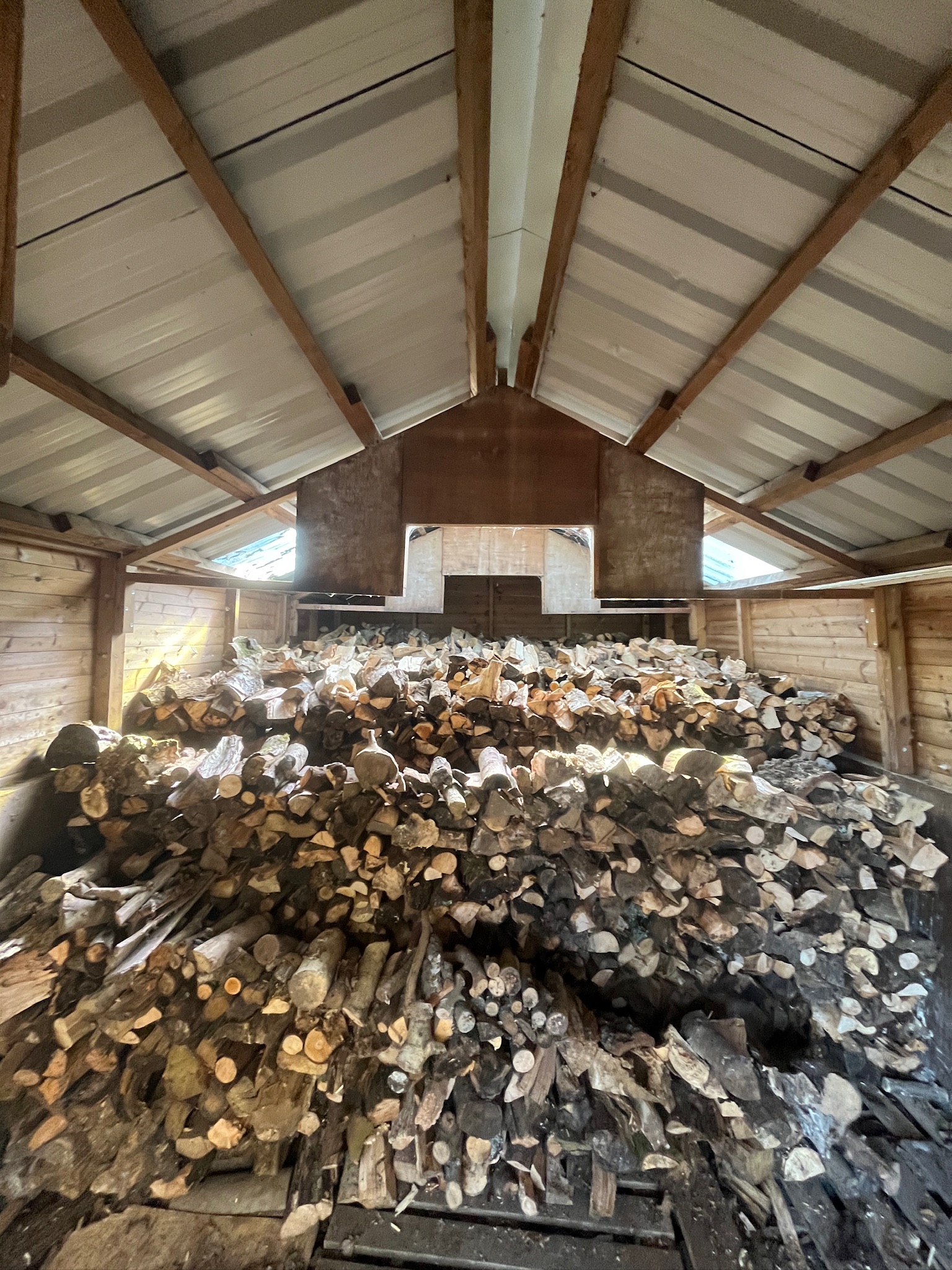 Seasoned firewood stacked in the log store