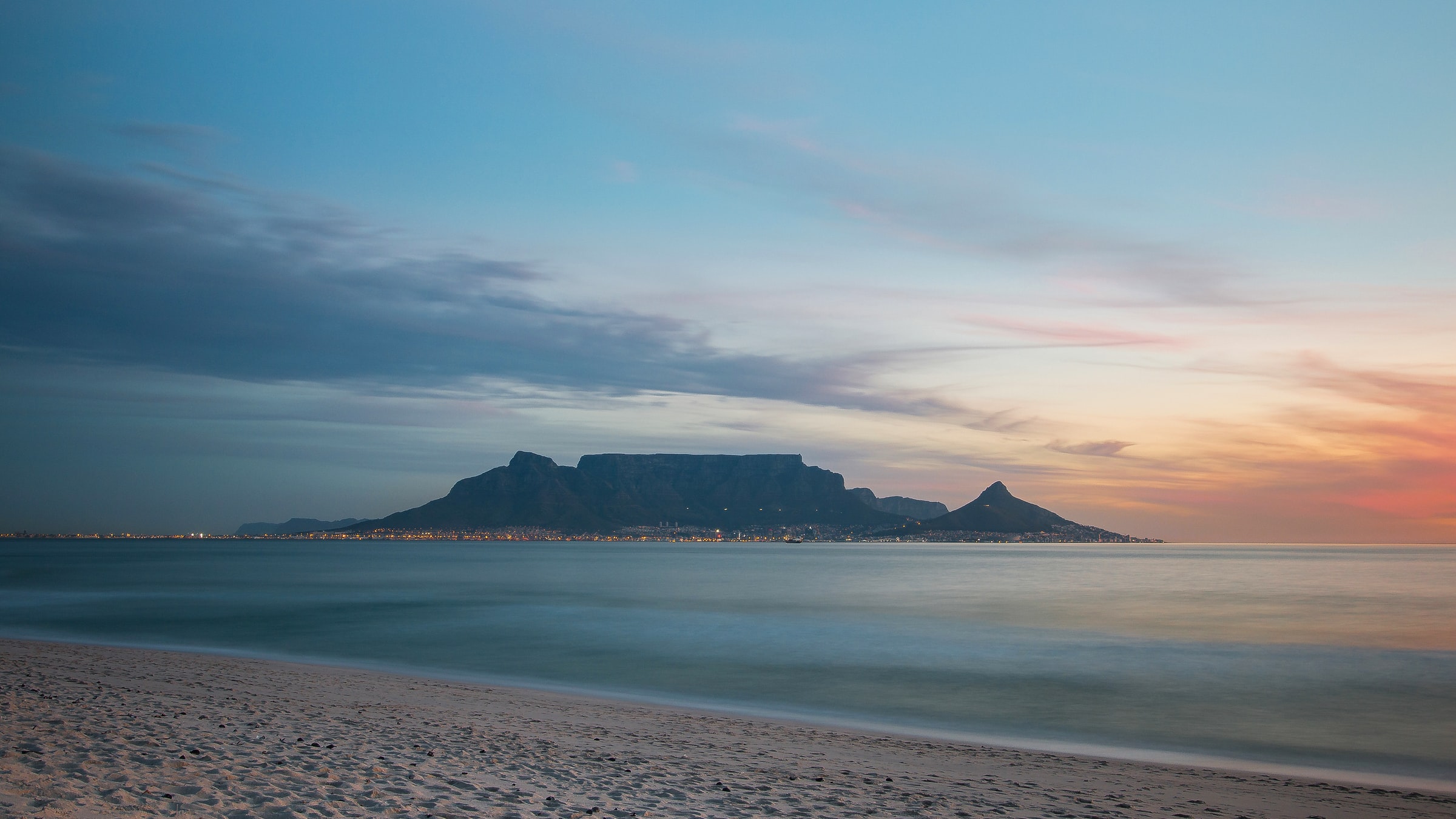 Table Mountain and Cape Town seen across the water at sunset