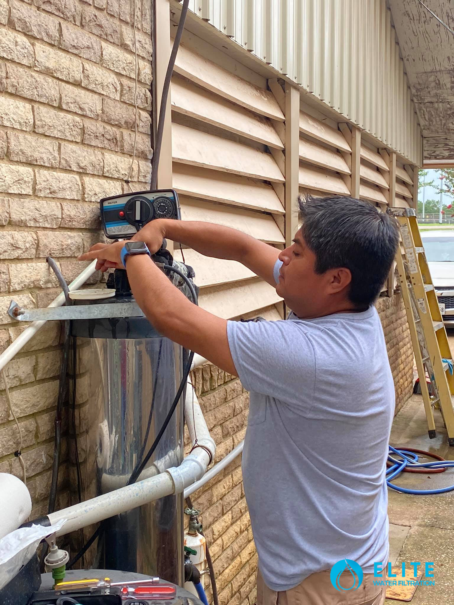 Technician installing water softner.