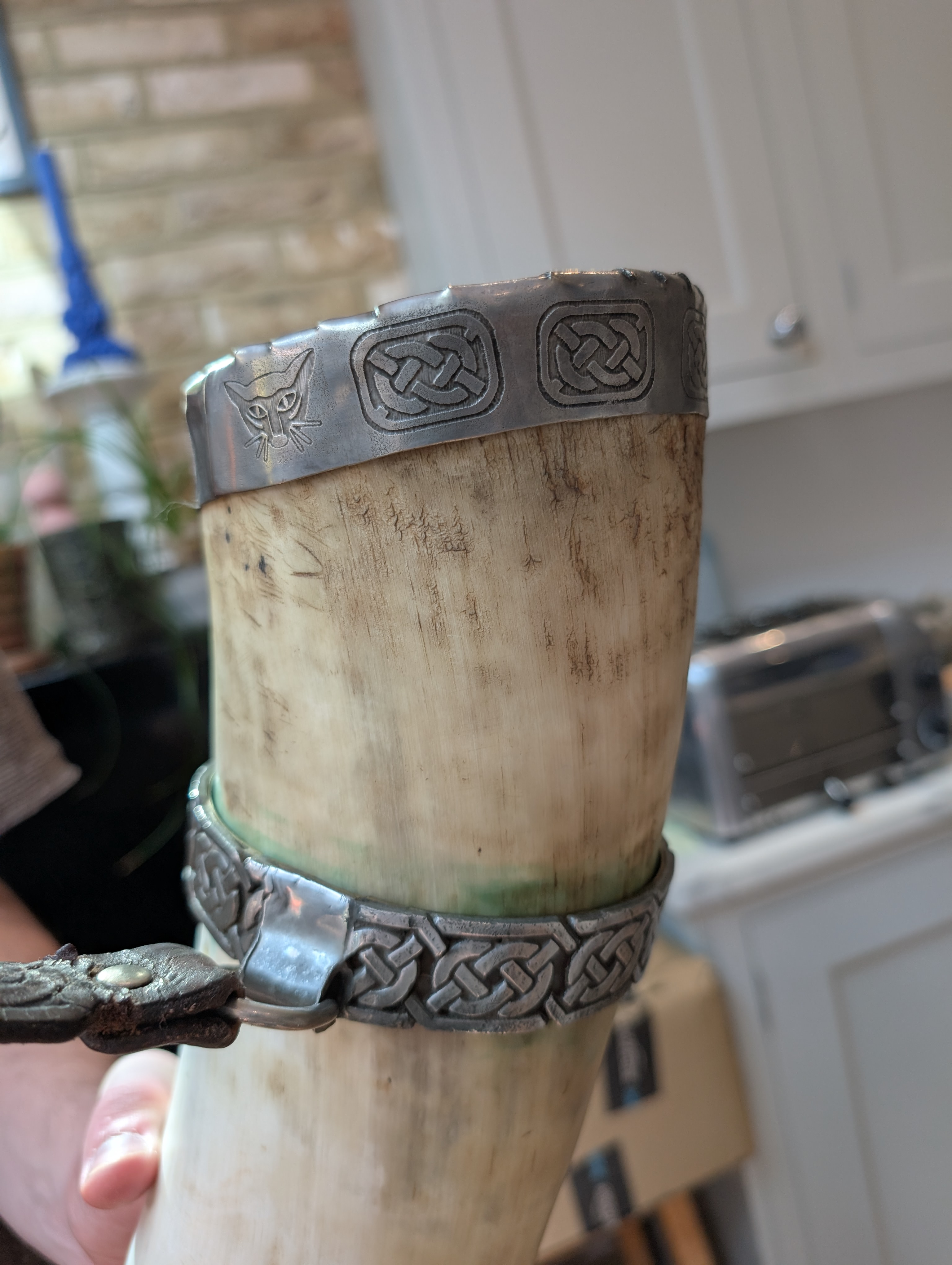 The existing carrying ring on the horn — cast Celtic knotwork, and the inspiration for the pattern we etched into the new rim cap