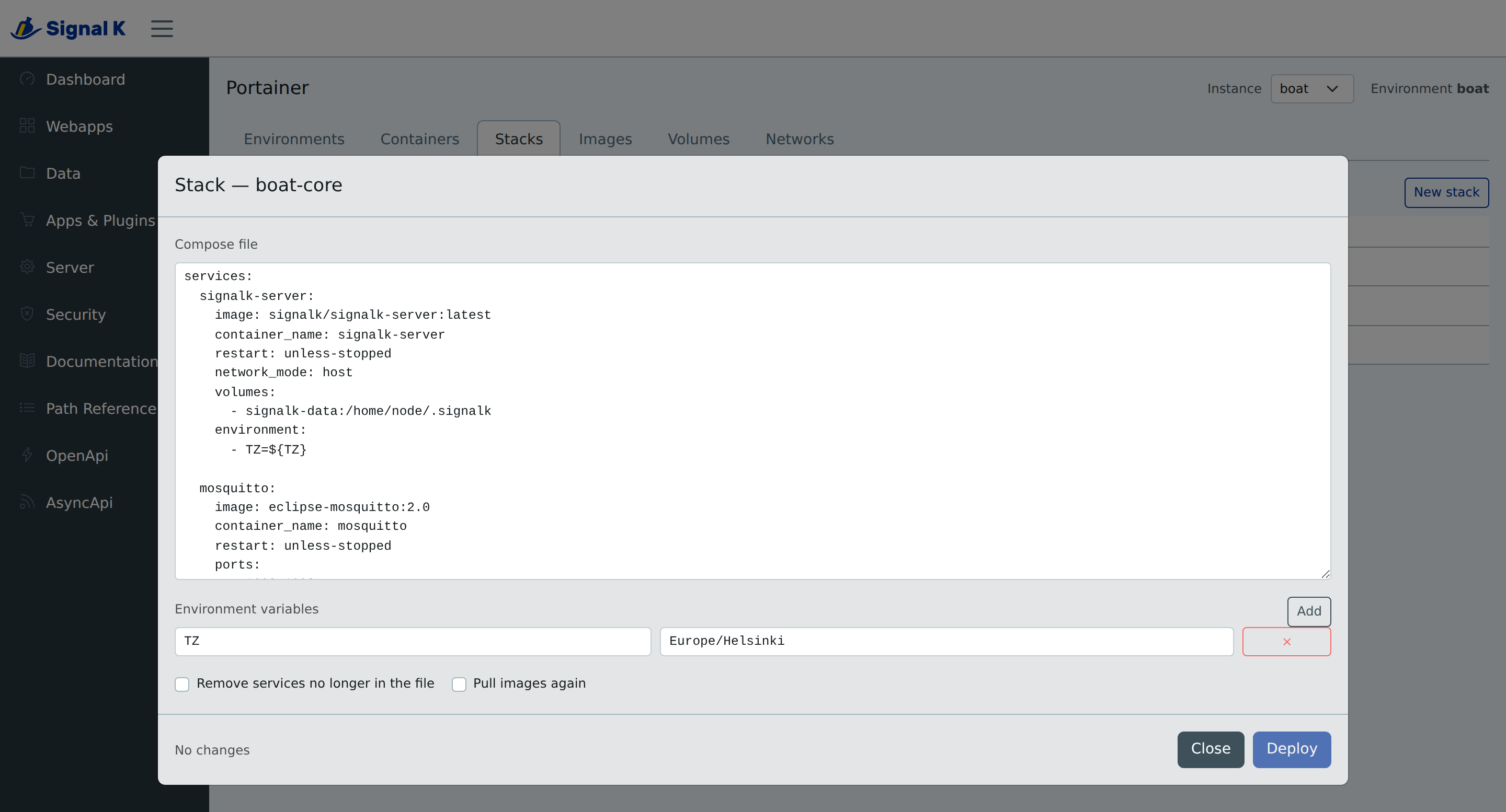 The stack editor open on a compose file, its environment variables listed below it, toggles for pruning and re-pulling, and a Deploy button disabled beside the words "No changes"