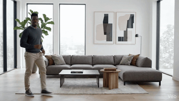 Horizontal 16:9 source clip of a man walking through a living room