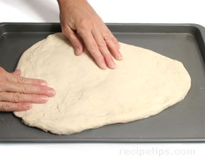 Pushing the dough out flat