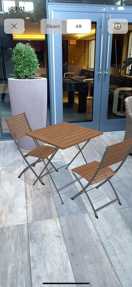 A model of chairs and a table placed in the real world and viewed in AR Mode