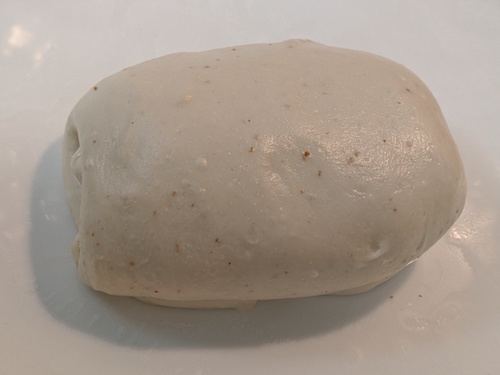 a folded dough with small bubbles under the surface