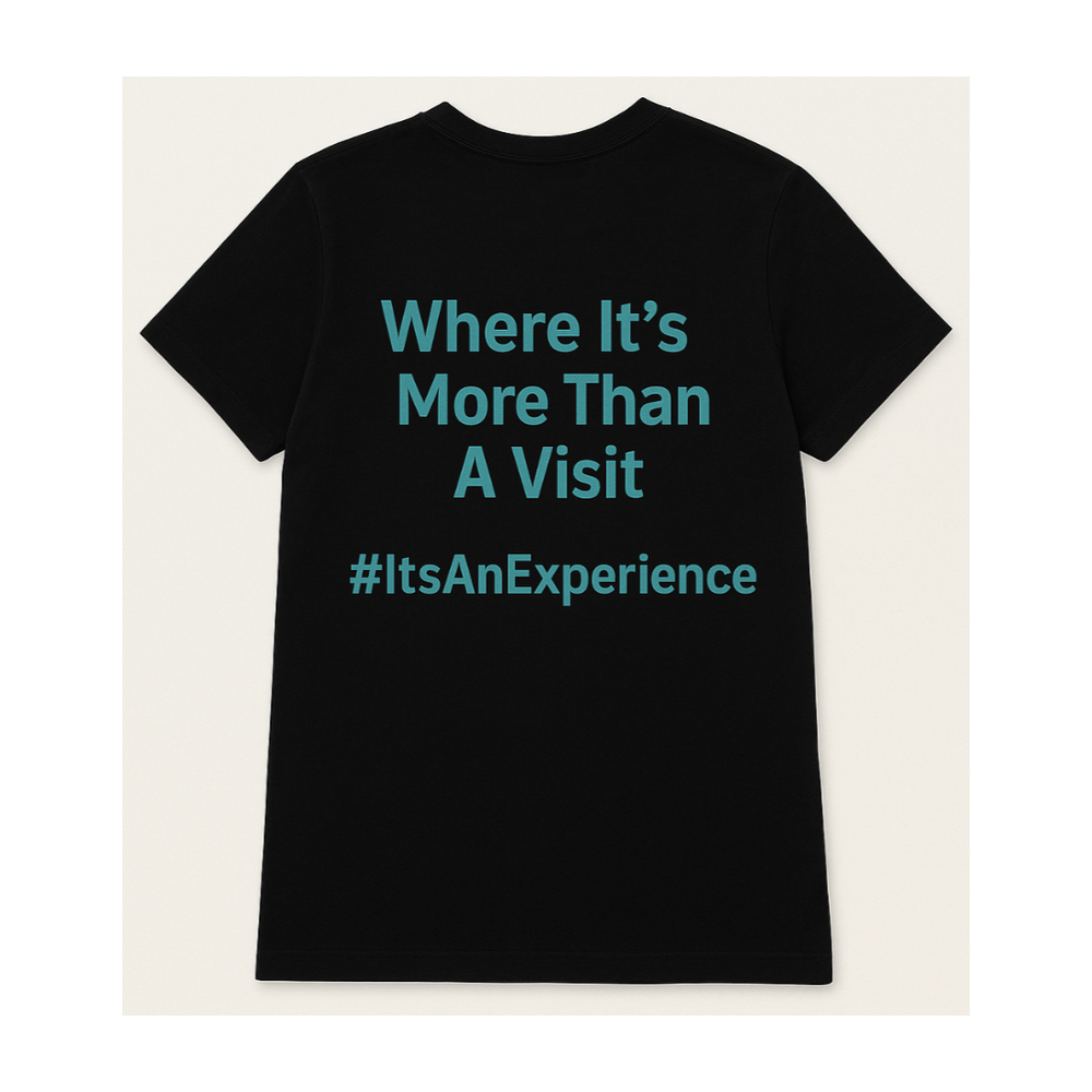 Black t-shirt reading Where It's More Than A Visit, hashtag ItsAnExperience