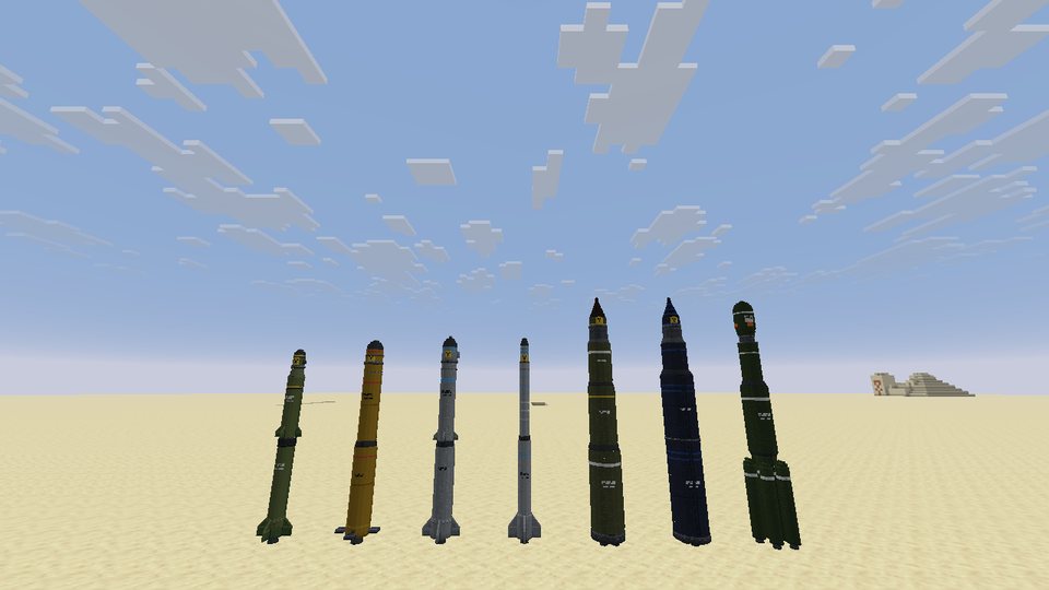 Seven nuclear missiles standing in a row on sand