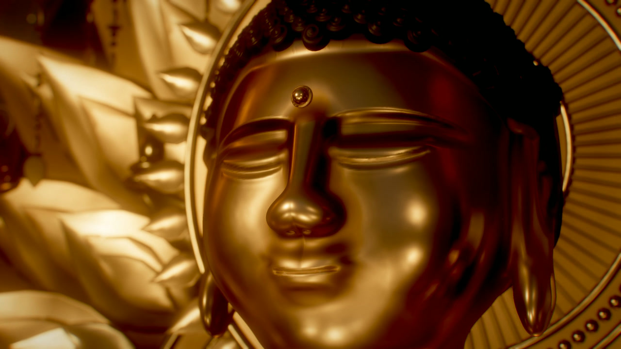Face of the golden Buddha in front of its halo