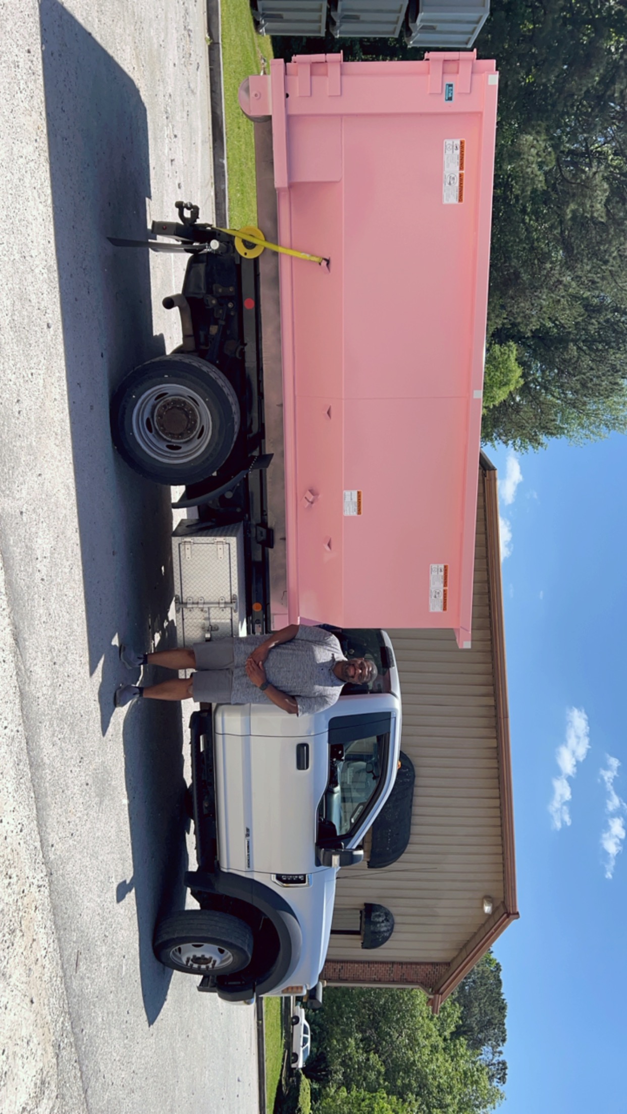 Marcus Griffin with a pink Little Junkers dumpster and truck