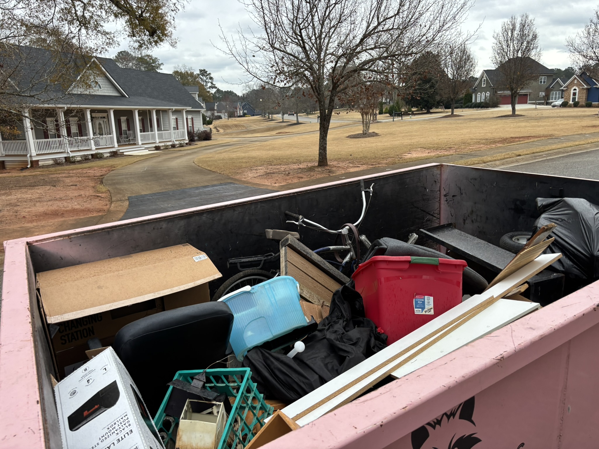 Dumpster loaded with residential cleanout junk