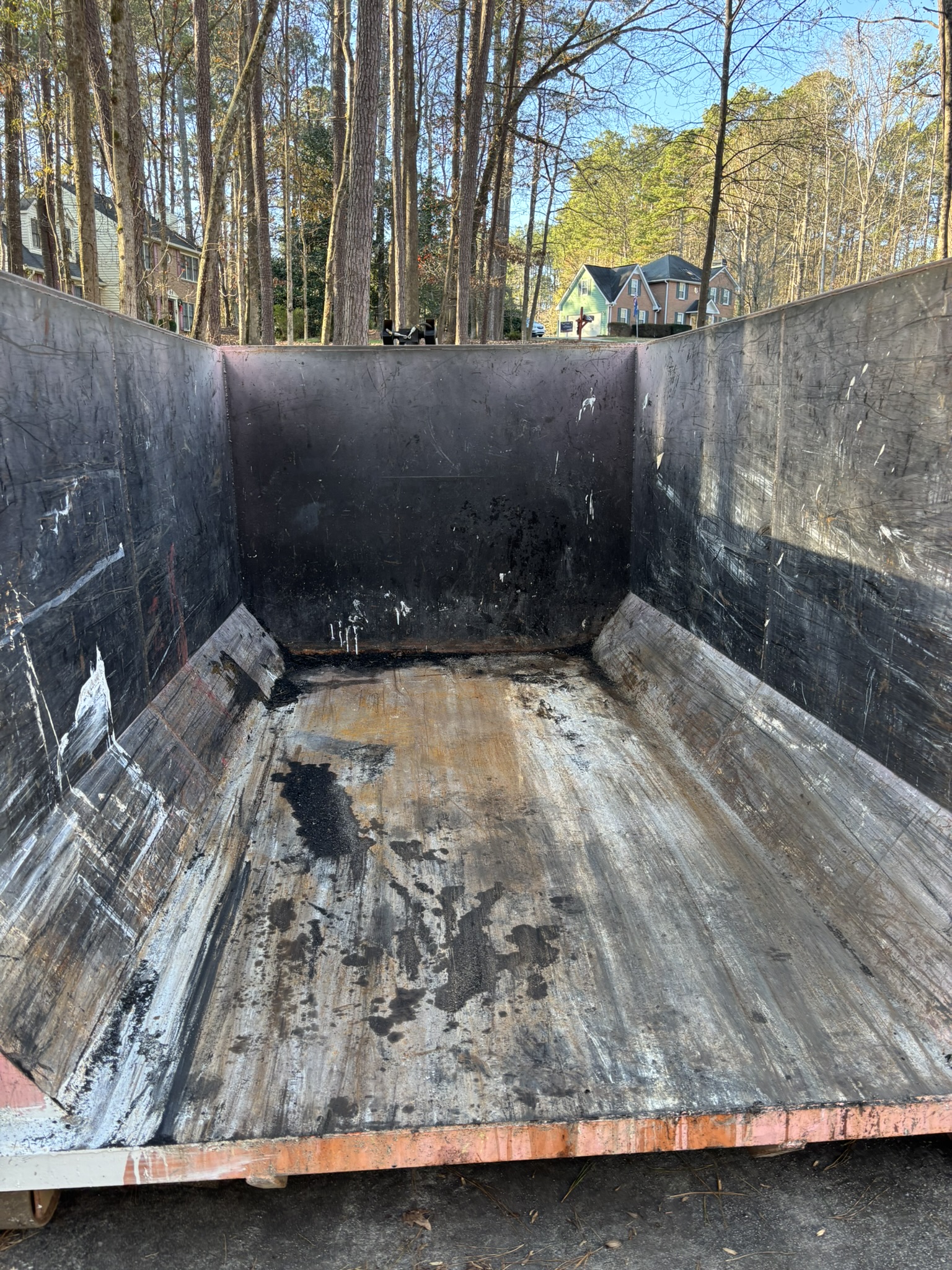 Clean black interior of empty 16-yard dumpster