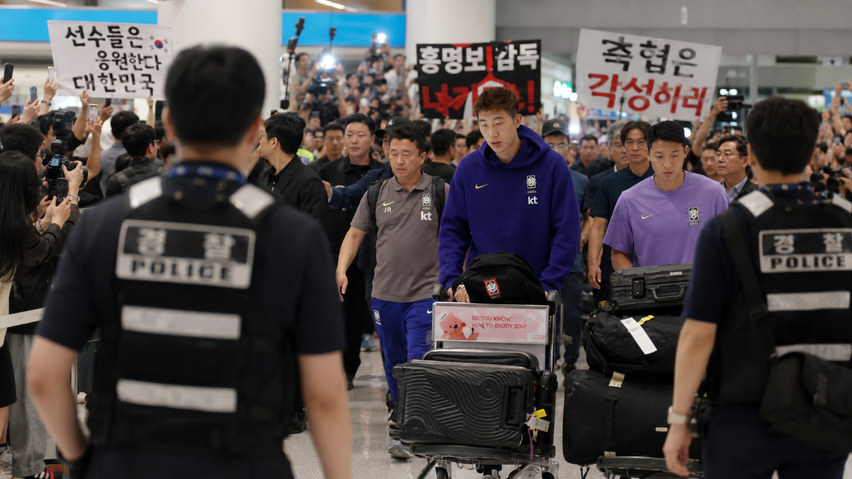 South Korea players escorted by police through Incheon Airport arrivals hall