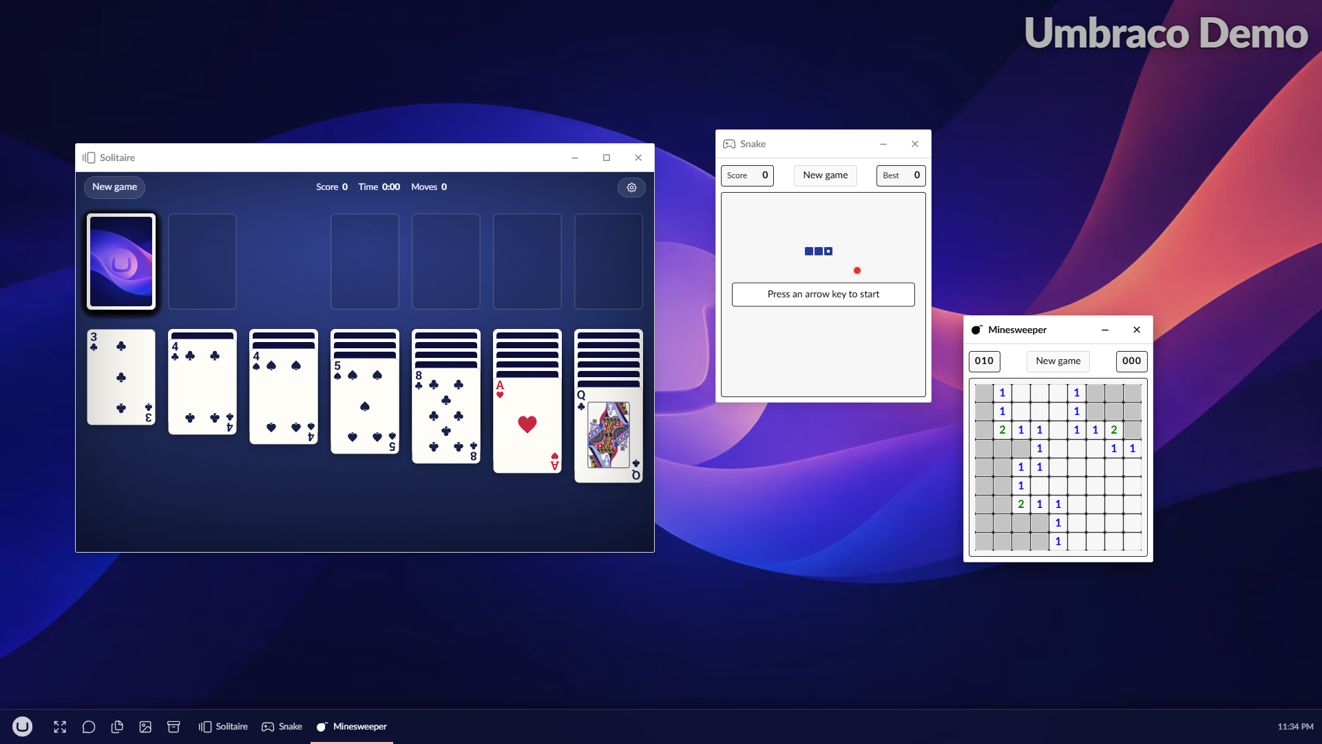 Solitaire, Snake and Minesweeper open side by side as three windows on the UmbraDesktop desktop under the Umbraco theme, each with its own button on the taskbar.