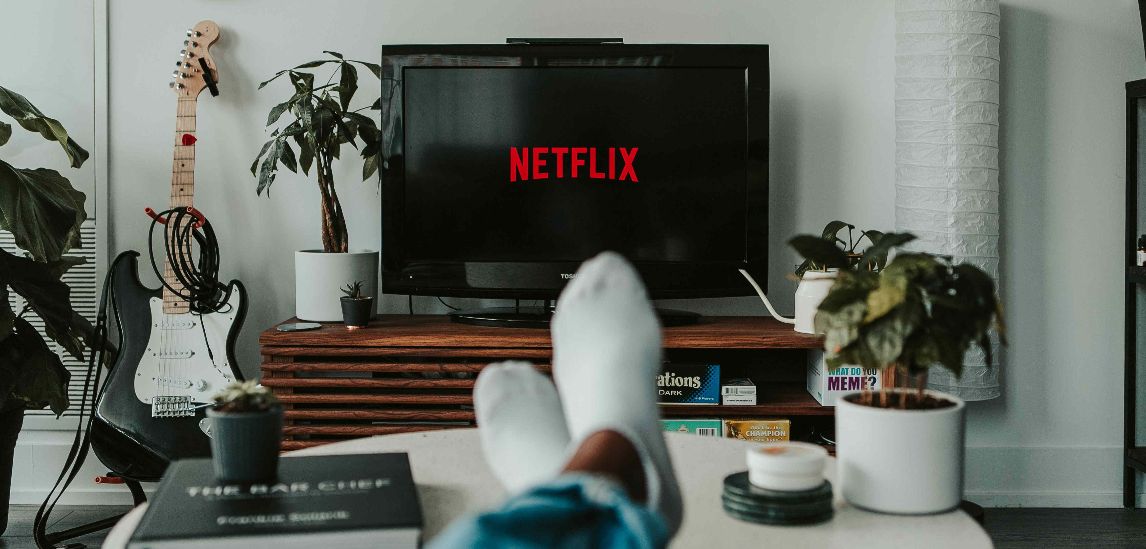 Someone's feet on table facing a television