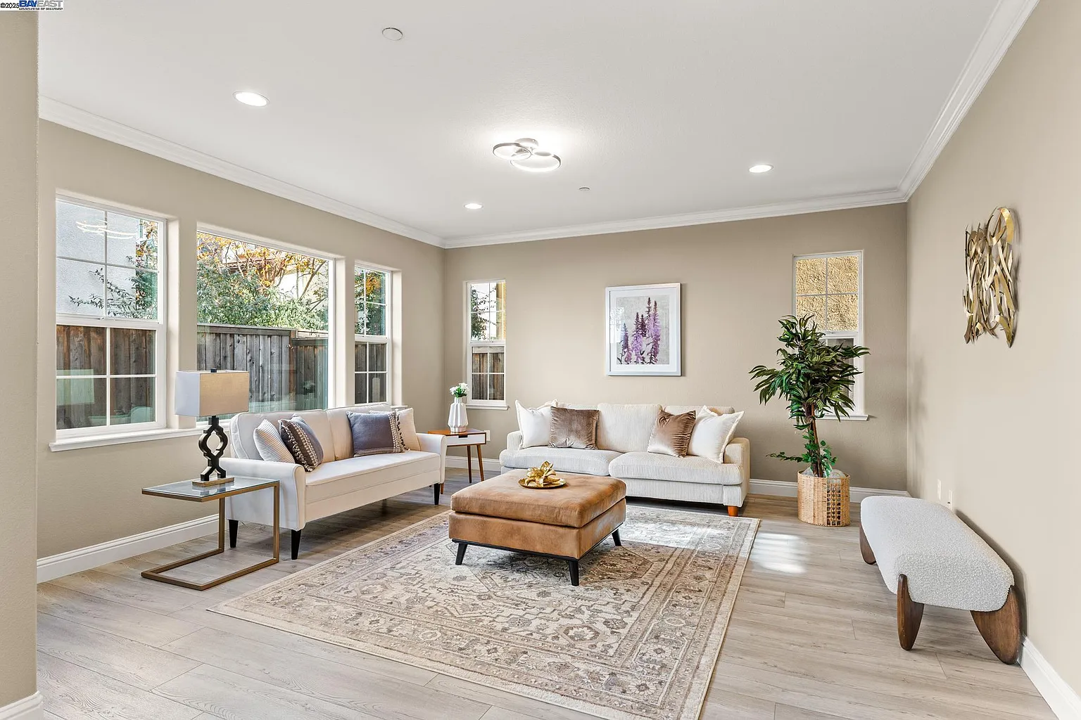 Bright living room staged with neutral seating and warm wood accents