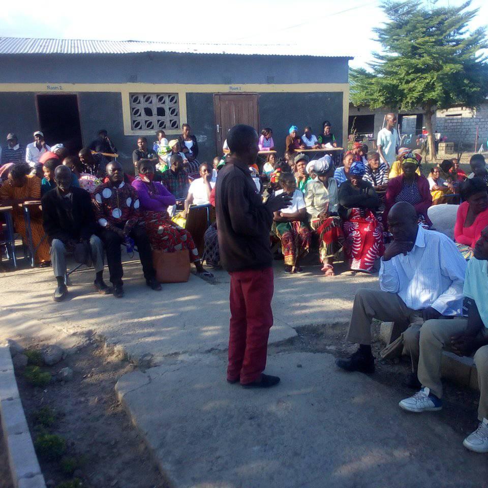 People sitting outside of Twatasha Disabled and OVC Organization