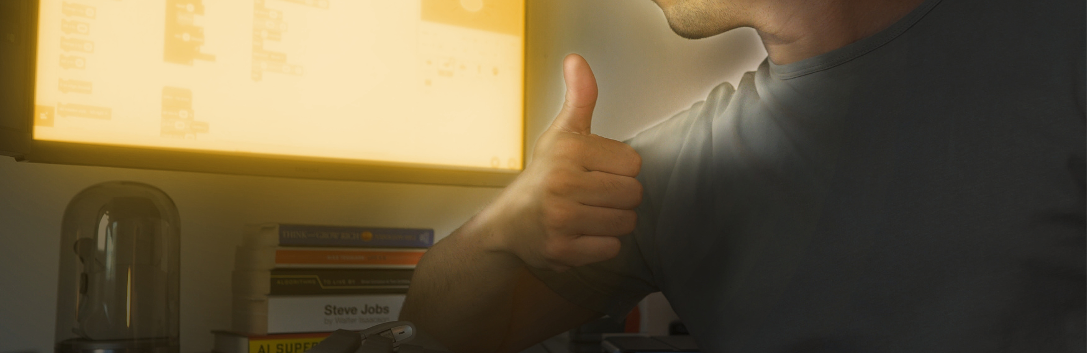 Banner of a developer sitting in front of a desk