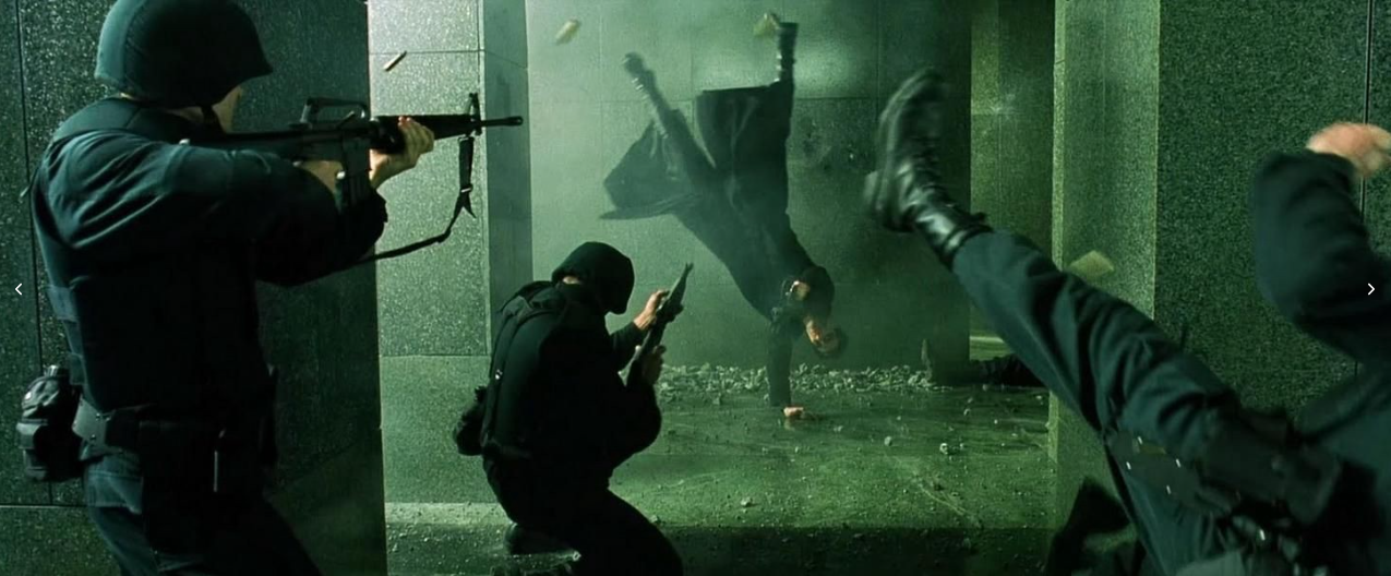 still from the memorable Lobby shootout set piece from the action film The Matrix (1999)