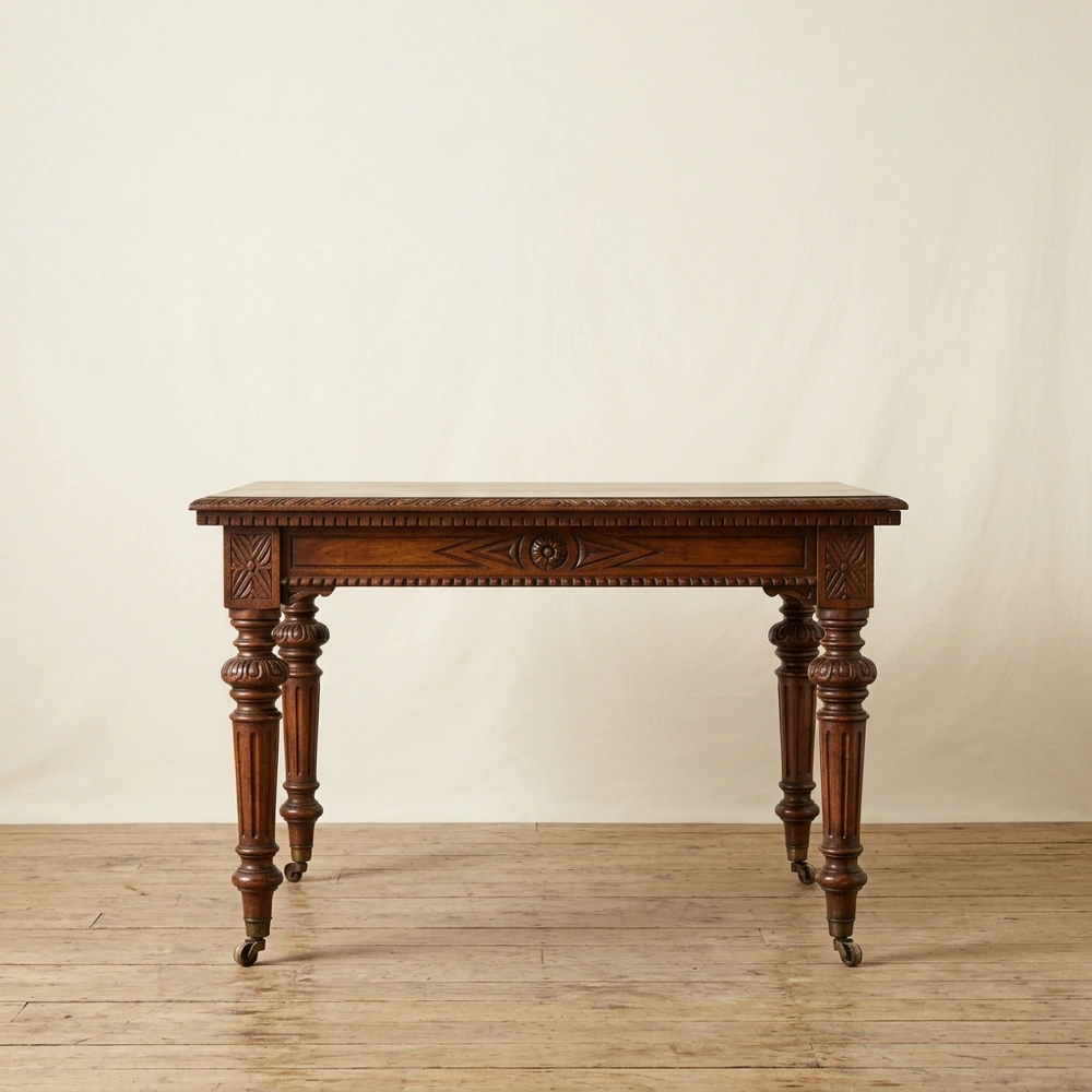 An antique mahogany dining table photographed in a studio.