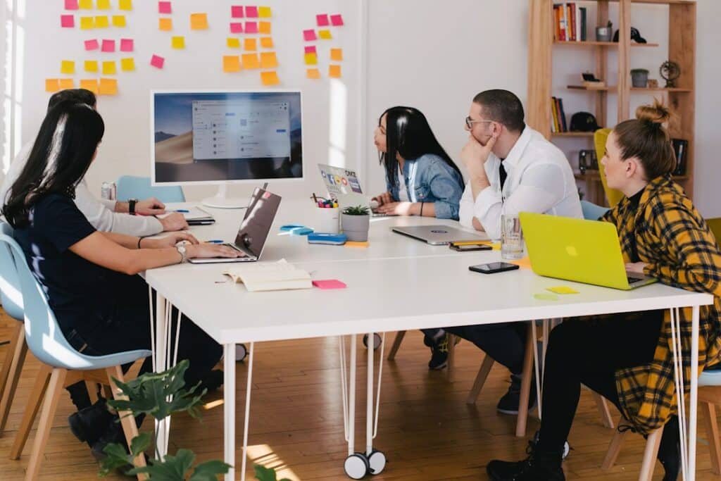 A team in an office discussing contact center software during a meeting