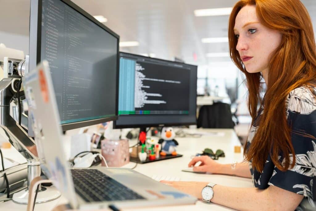 A woman in an office researching contact center software on her computer