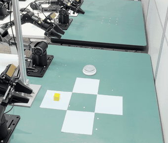 Real-robot Put Back Block, initial position Down: the block starts on the mat nearest the arm bases