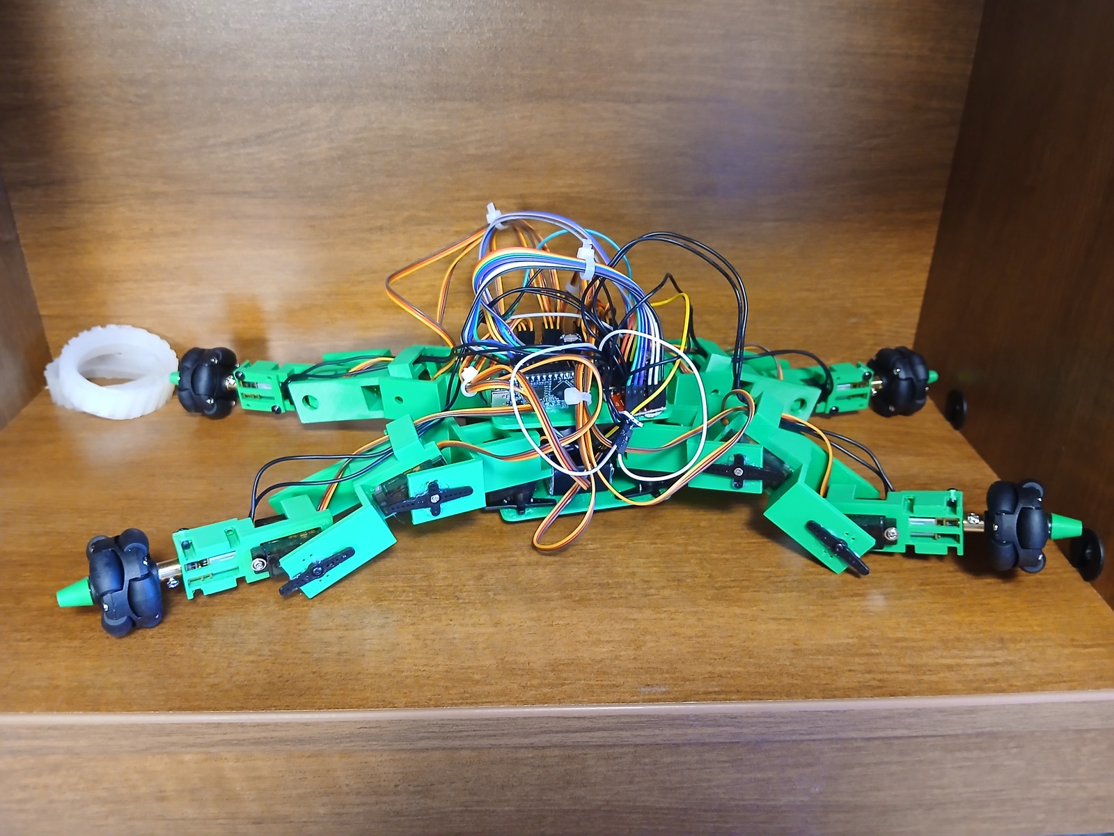 Current green hybrid robot resting on a shelf