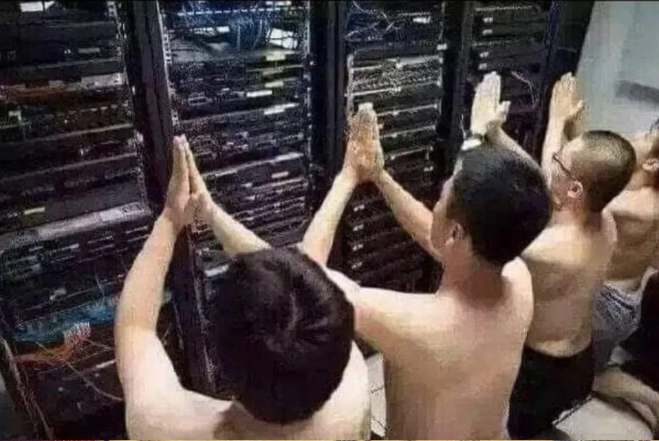 multiple people praying to a server rack