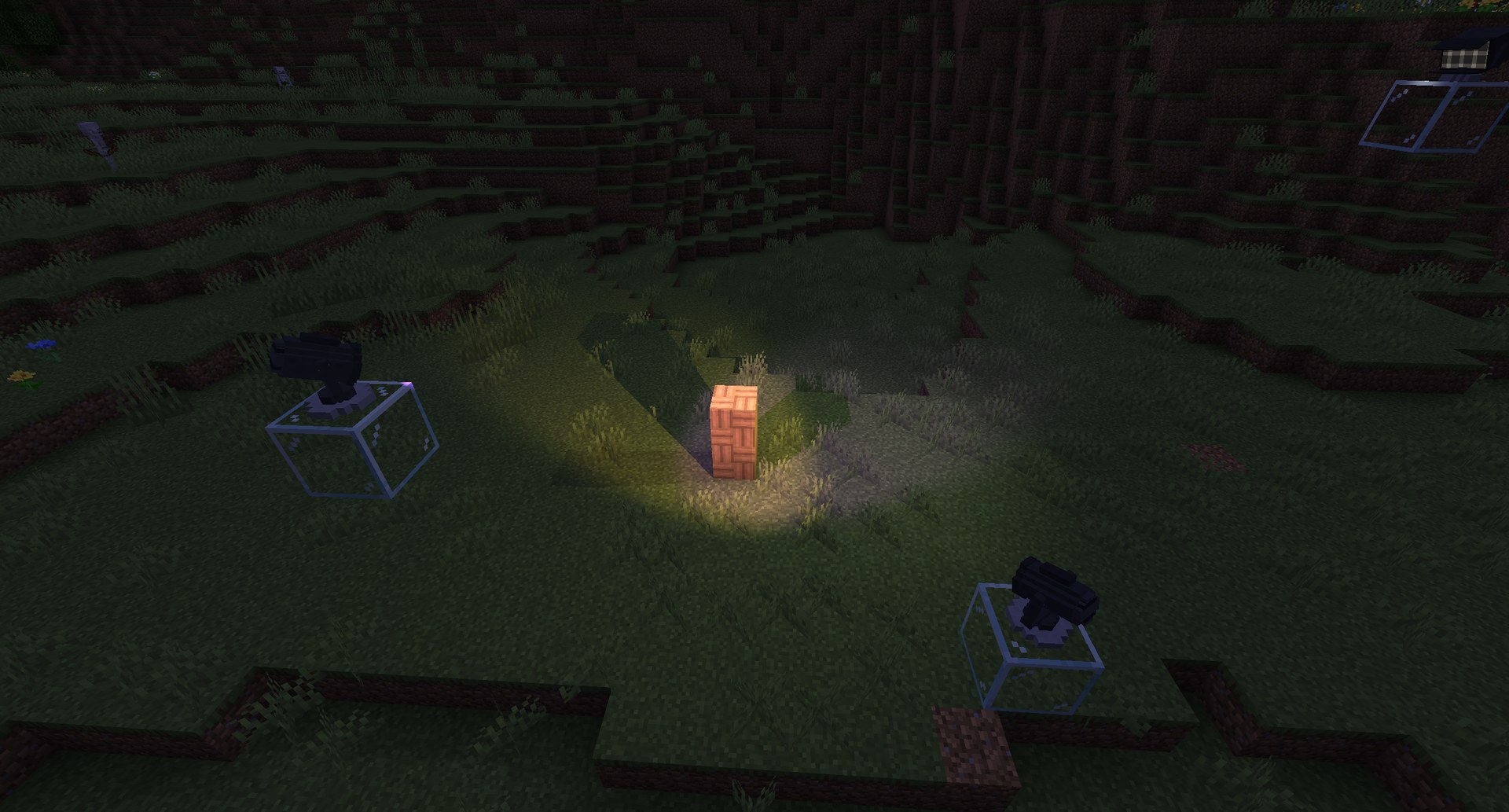 Spotlights on glass stands lighting a block at dusk