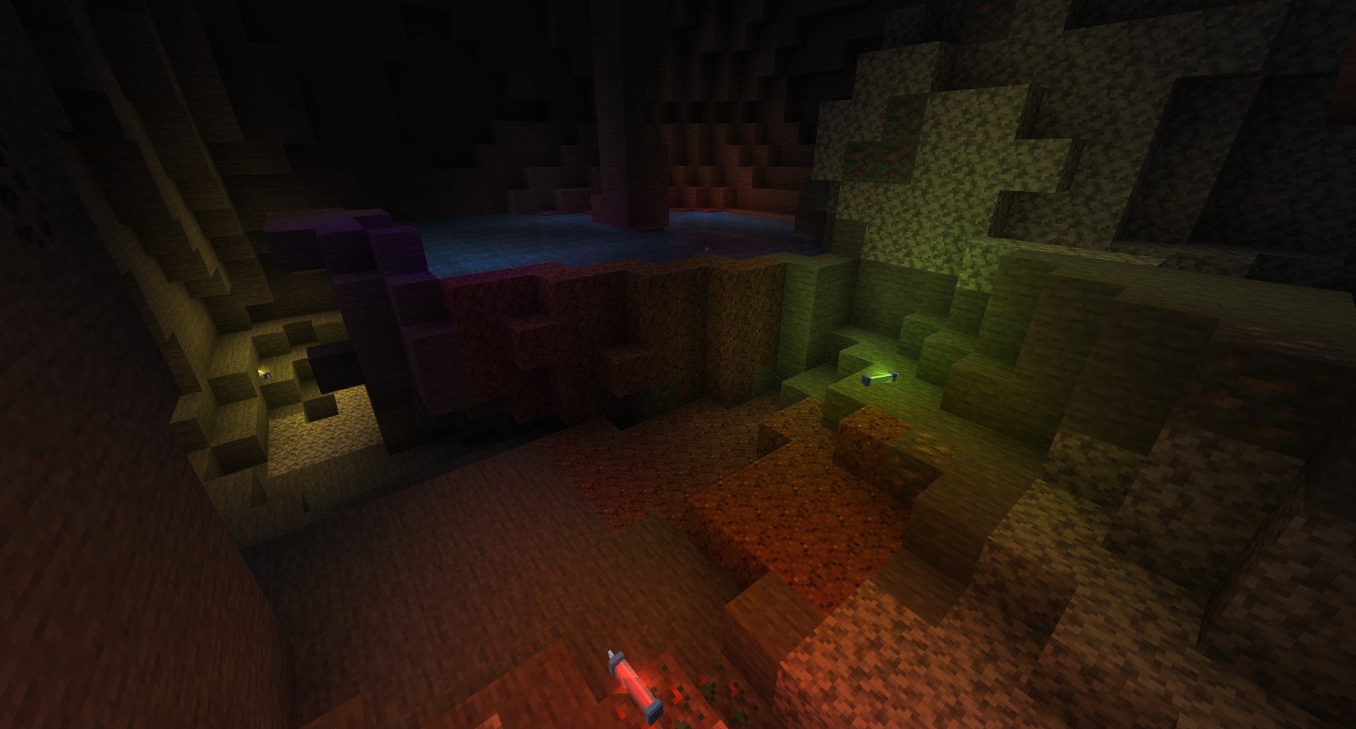 Thrown glowsticks light up a cave in their own colors