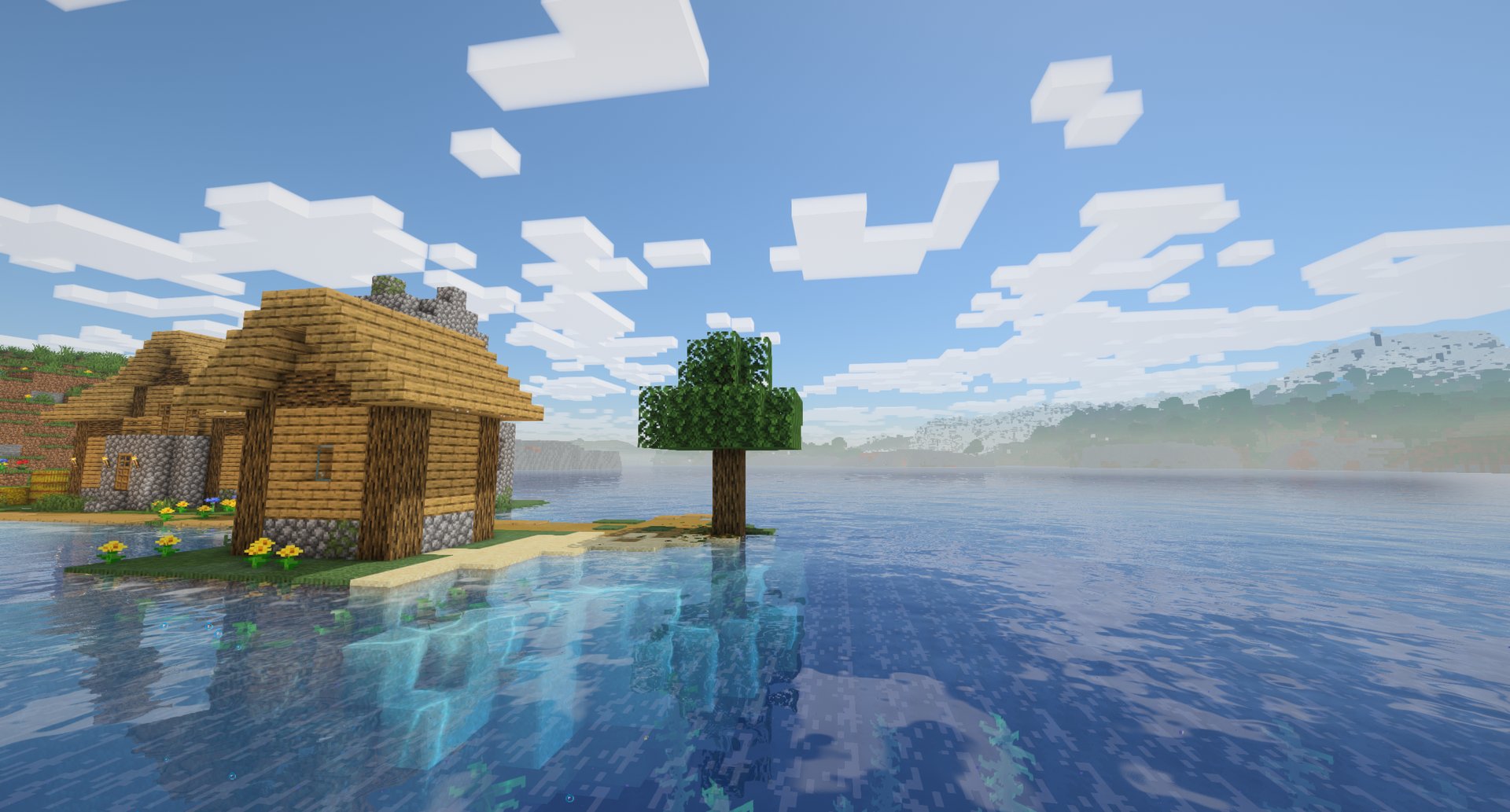 A lake village at noon: clear water, reflections and soft haze
