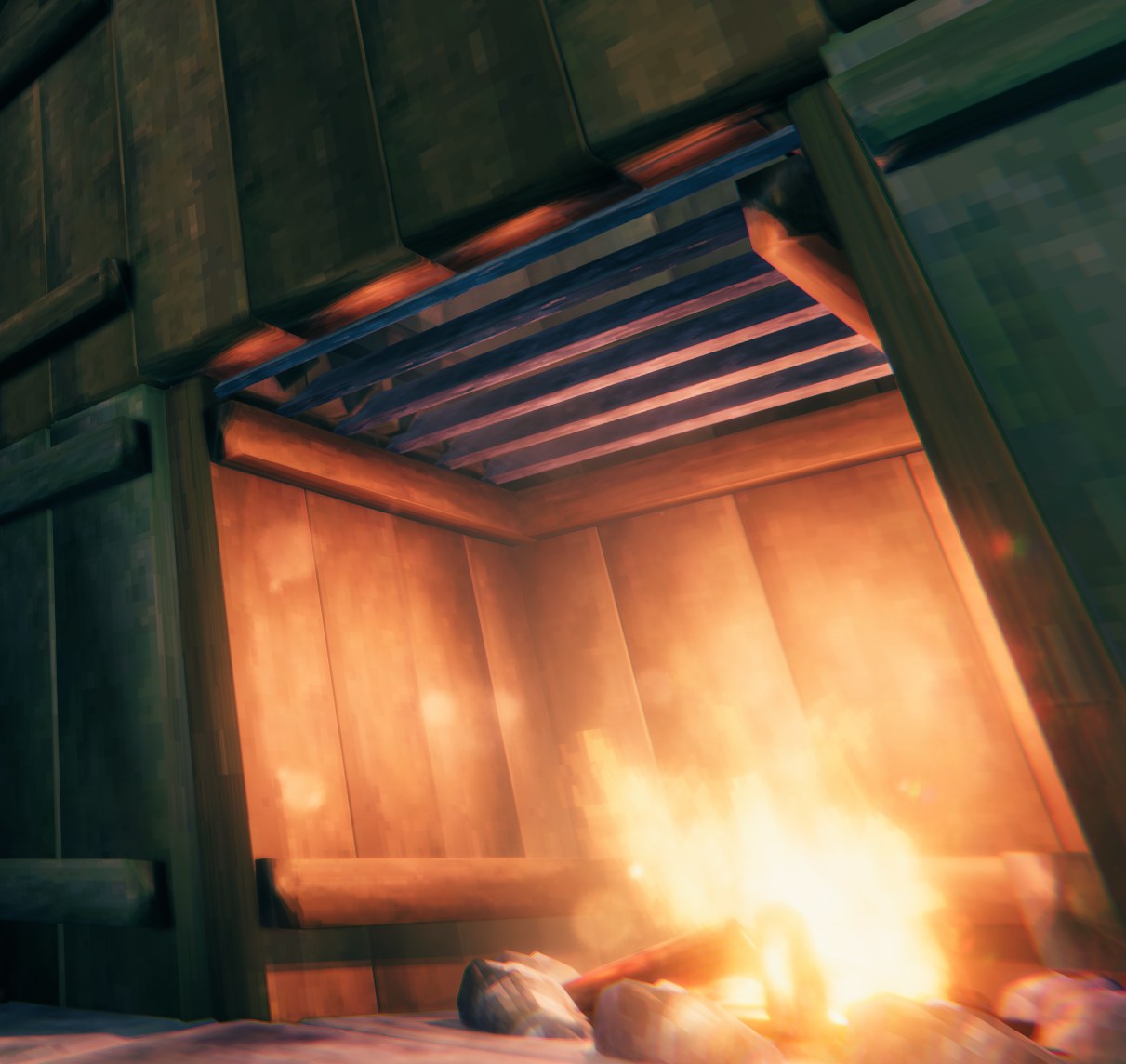 Quan's Chimney Flue seen from below, its stone louvres above a lit campfire inside a wooden chimney